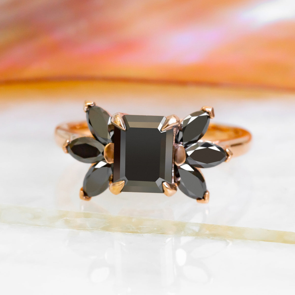 Black Scorpio emerald cut black diamond engagement ring with black marquise side stones in rose gold