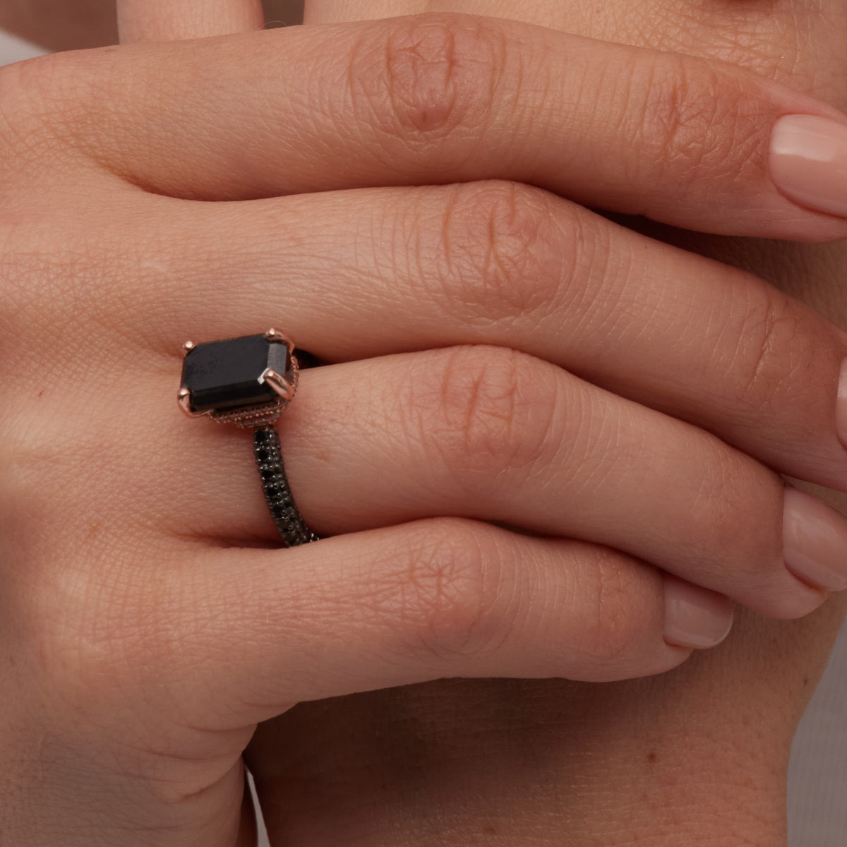 Oscura Magia emerald cut black diamond ring, close-up on the finger