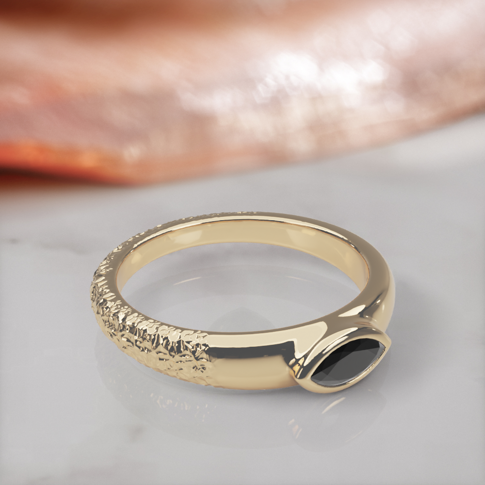 Disturbed engagement ring in yellow gold, three-quarter view showing the hammered, textured side of the band