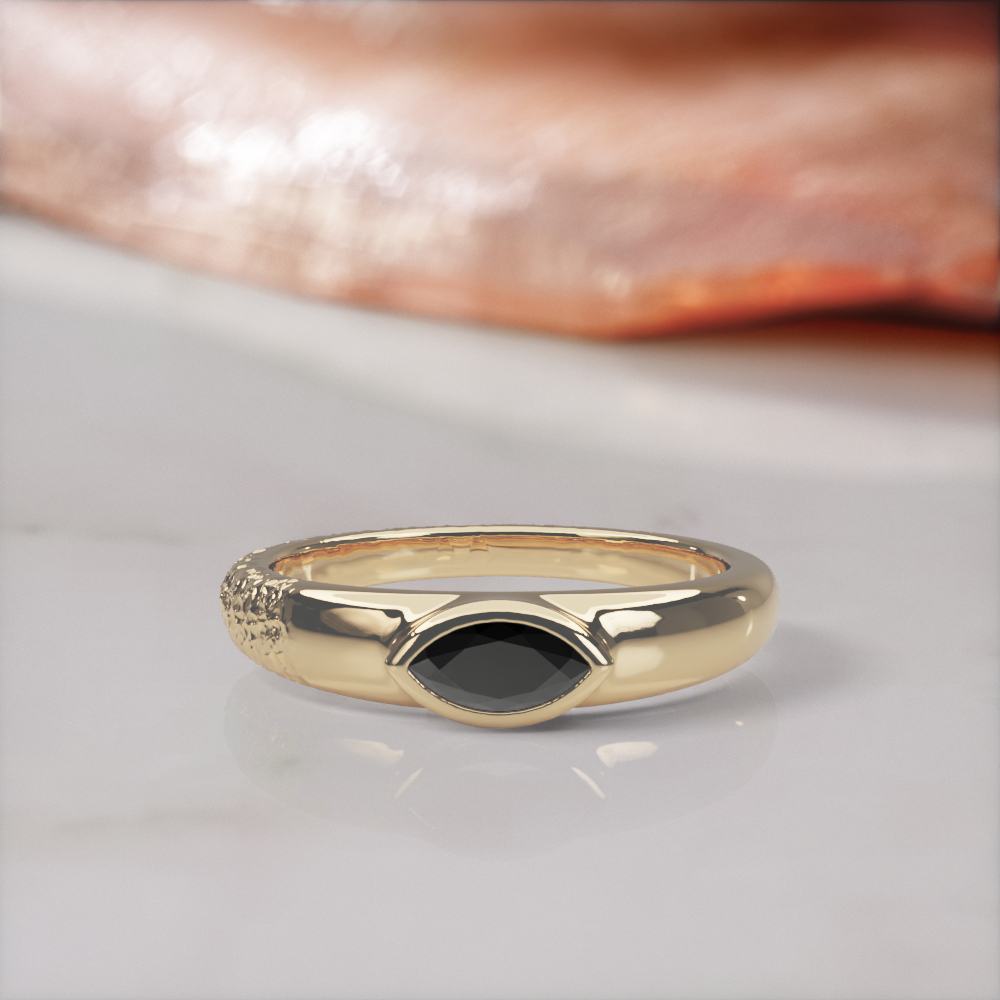 Disturbed engagement ring in yellow gold, front view of the marquise black diamond low in its polished bezel