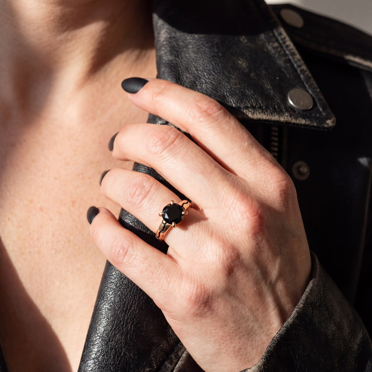 Kintsugi black diamond ring in rose gold, hand on a black leather jacket