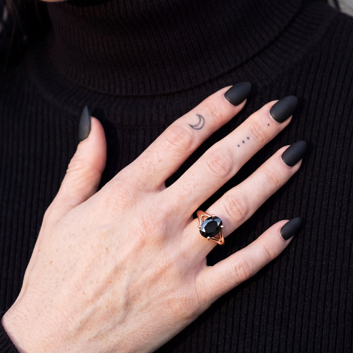Melusine oval natural black diamond split shank engagement ring worn on the hand in rose gold