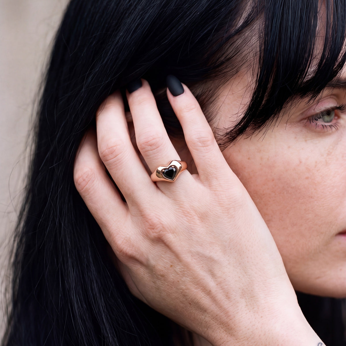 Cor Caroli heart shaped natural black diamond bezel ring worn on the hand in rose gold