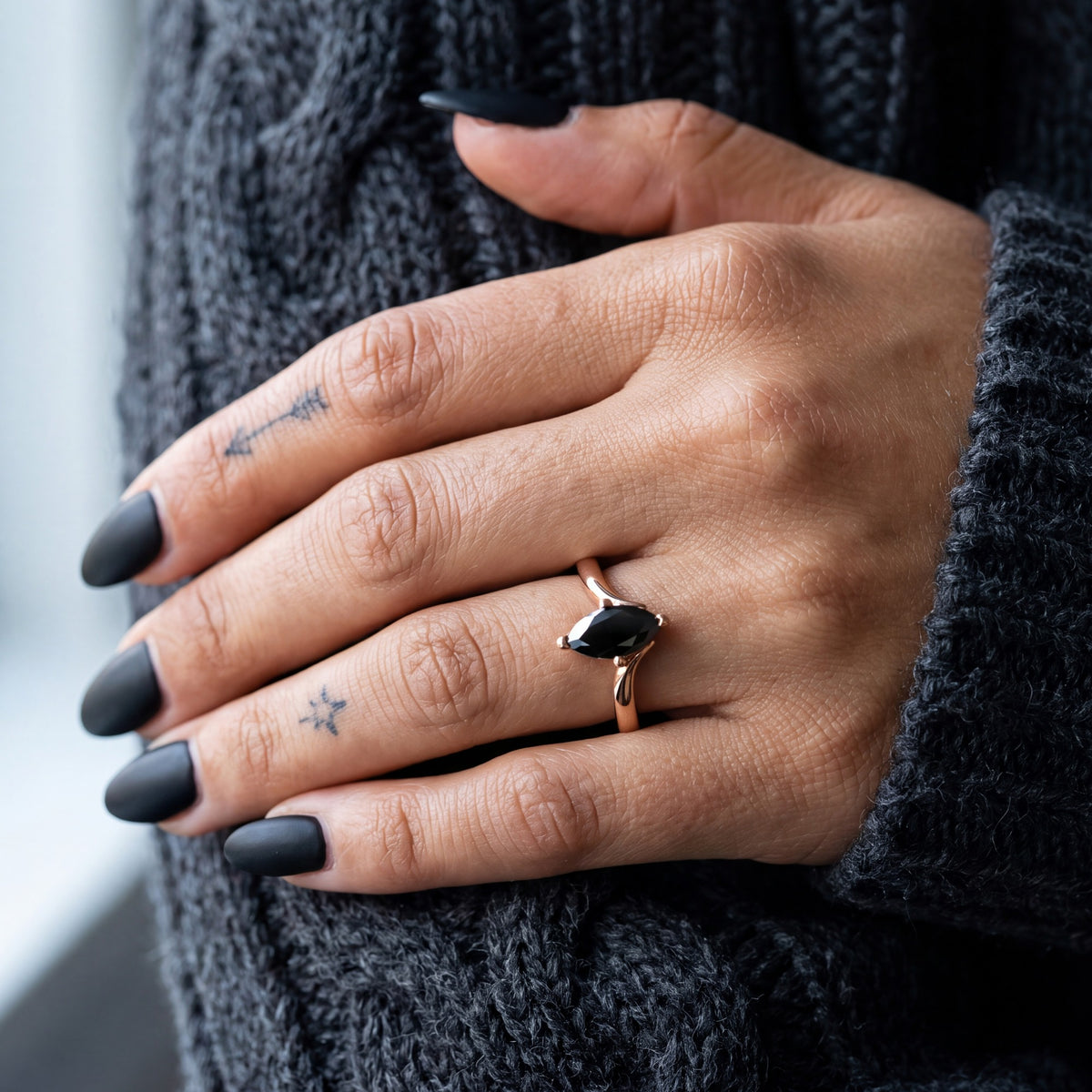 Phoenix marquise natural black diamond bypass engagement ring worn on the hand in rose gold