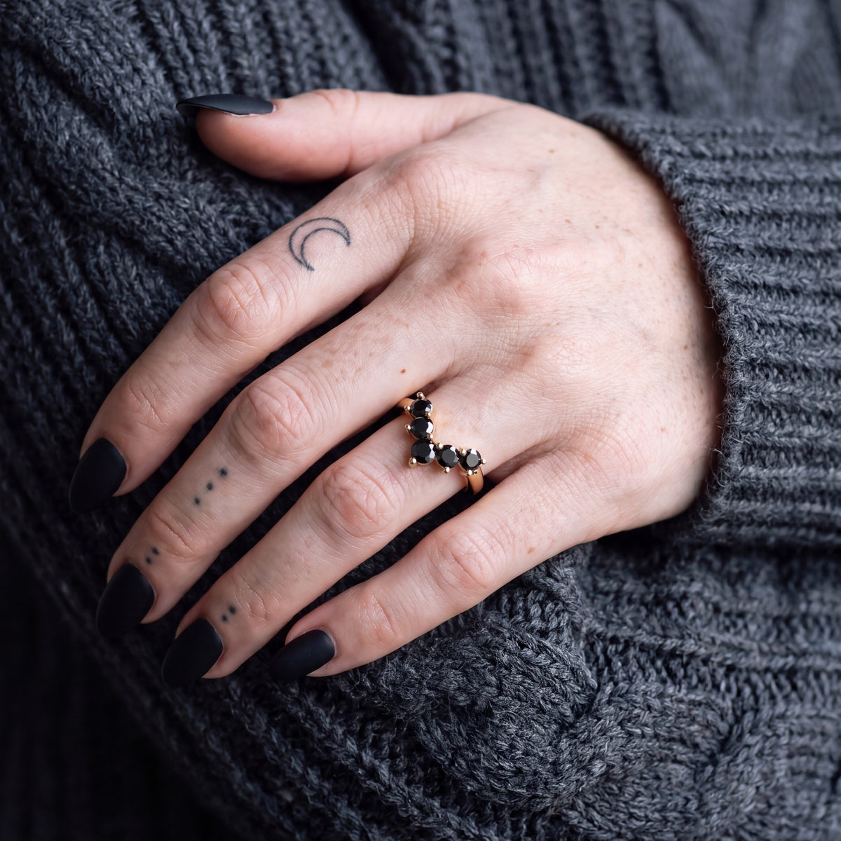 Hyades chevron natural black diamond contour wedding band worn on the hand in yellow gold