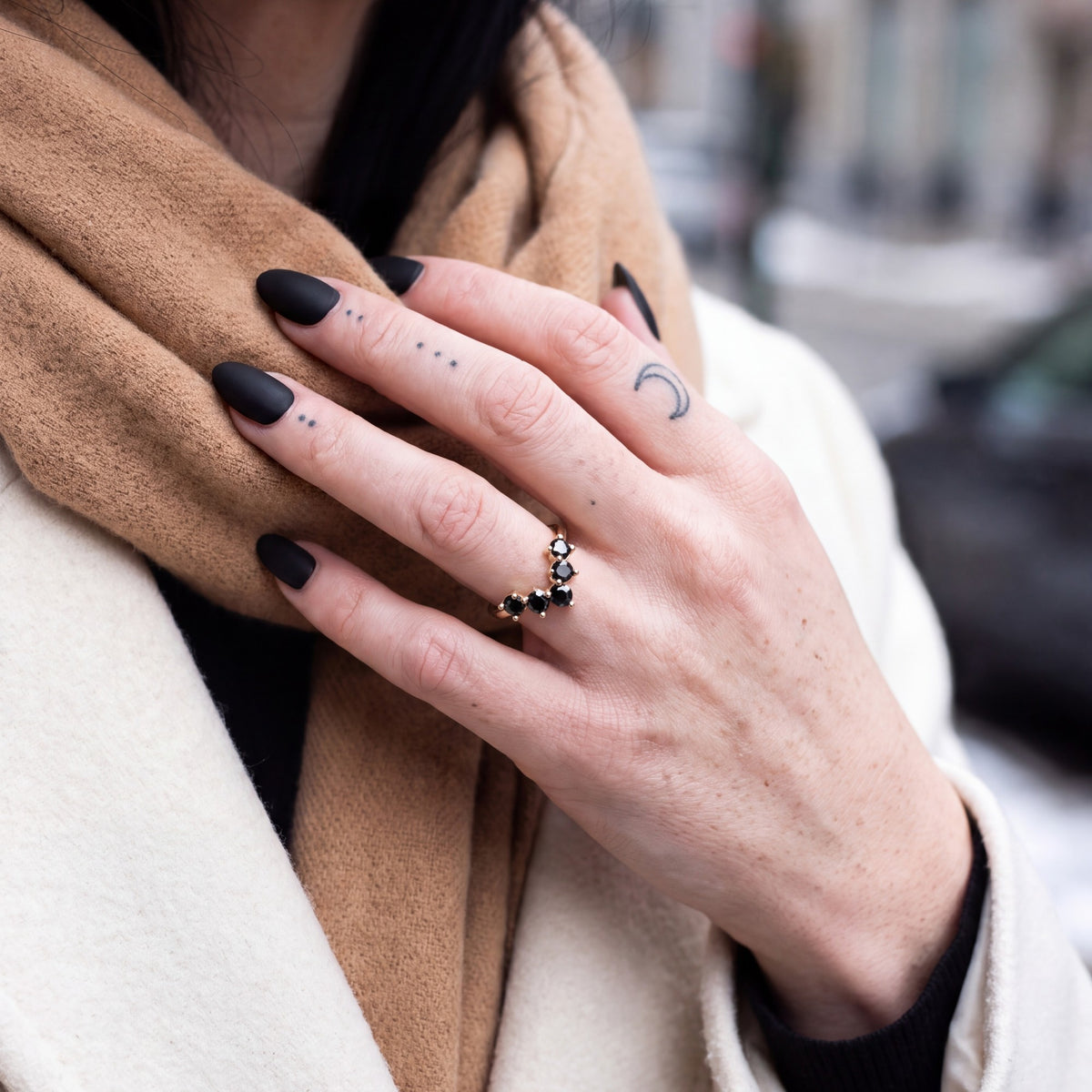 Hyades chevron natural black diamond contour band in yellow gold, adjusting a camel scarf