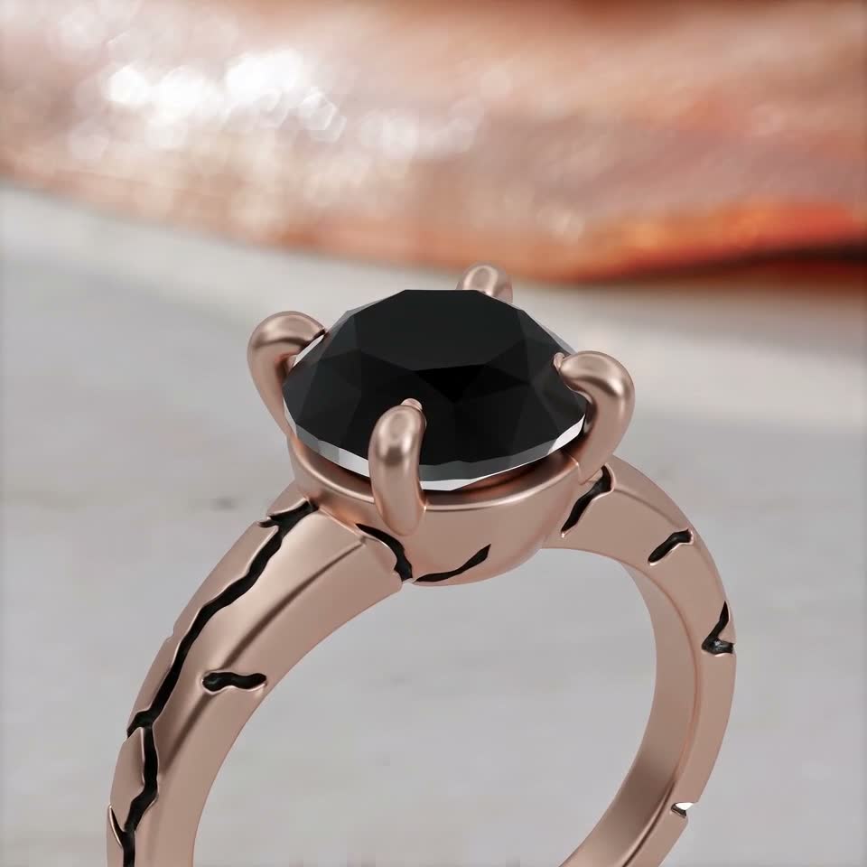 The Kintsugi ring assembling: the black diamond drops, the claws close, the band turns to the light