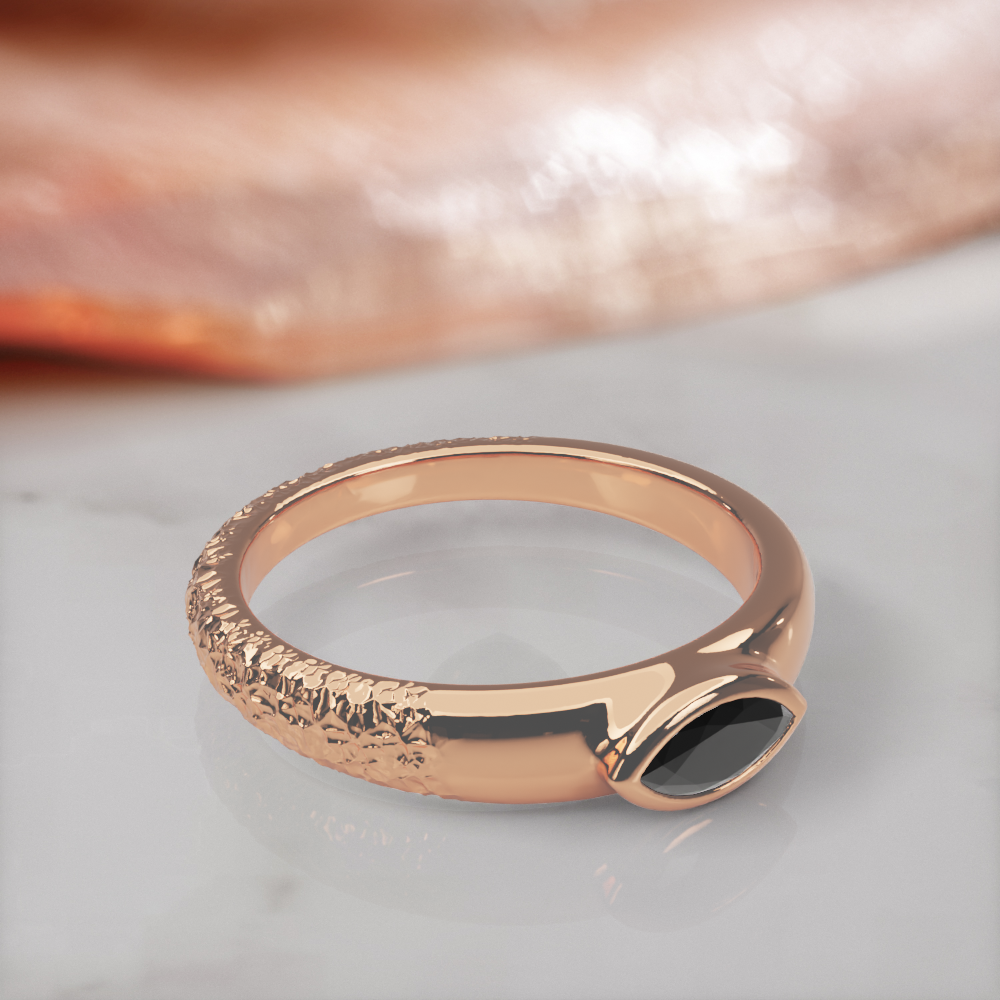 Disturbed engagement ring in rose gold, three-quarter view showing the hammered, textured side of the band