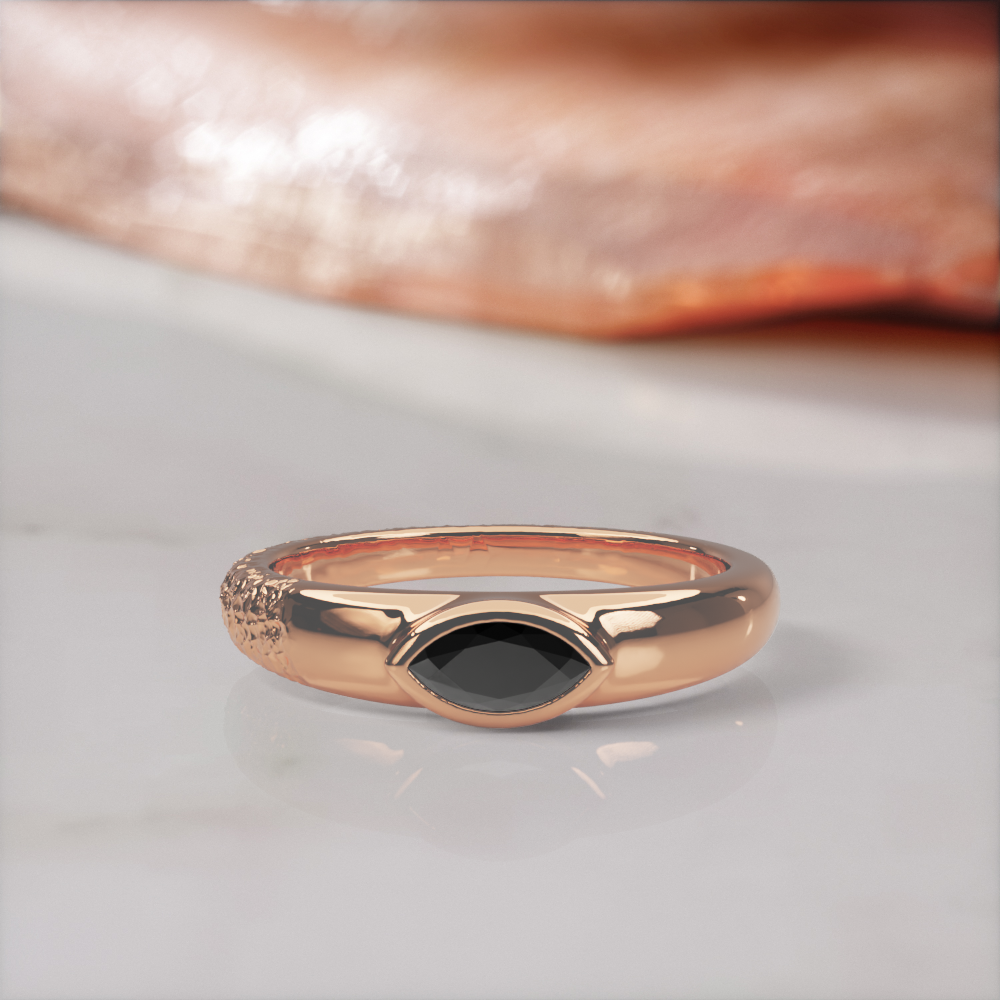 Disturbed engagement ring in rose gold, front view of the marquise black diamond low in its polished bezel