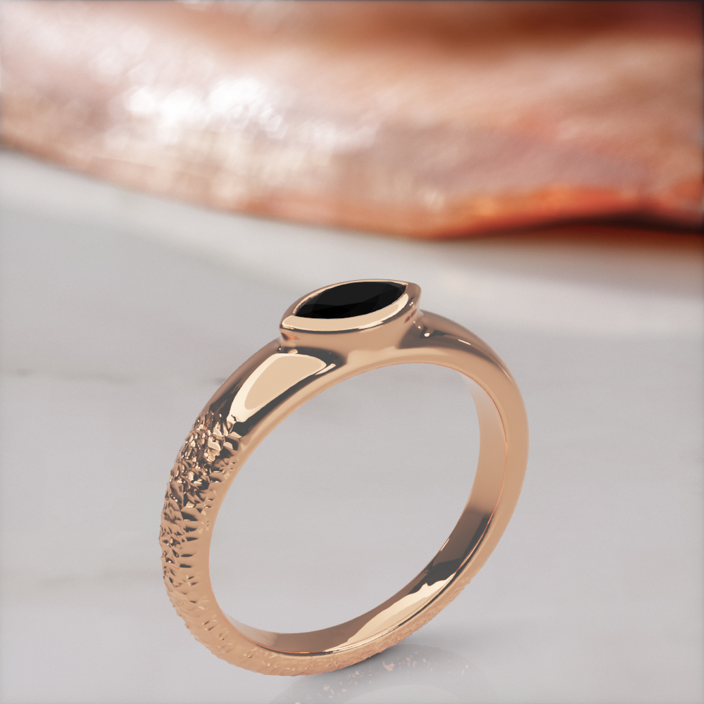 Disturbed engagement ring in rose gold standing upright, three-quarter view of the rough and polished halves of the band
